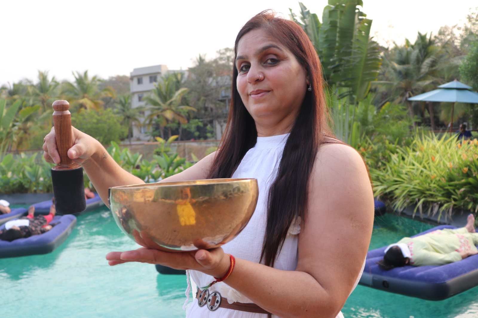 Ritu Pherwani, certified sound healing practitioner, holding a singing bowl